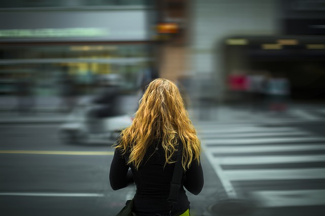 millennial crossing a city street